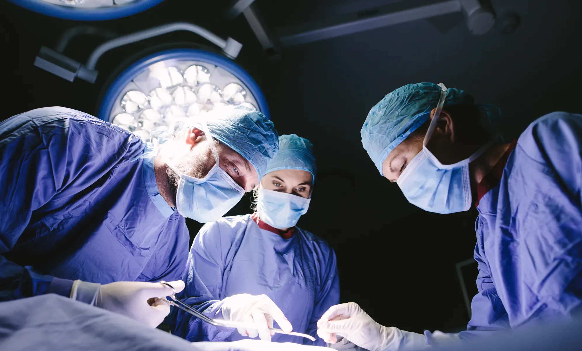 A surgical team operating under the lights