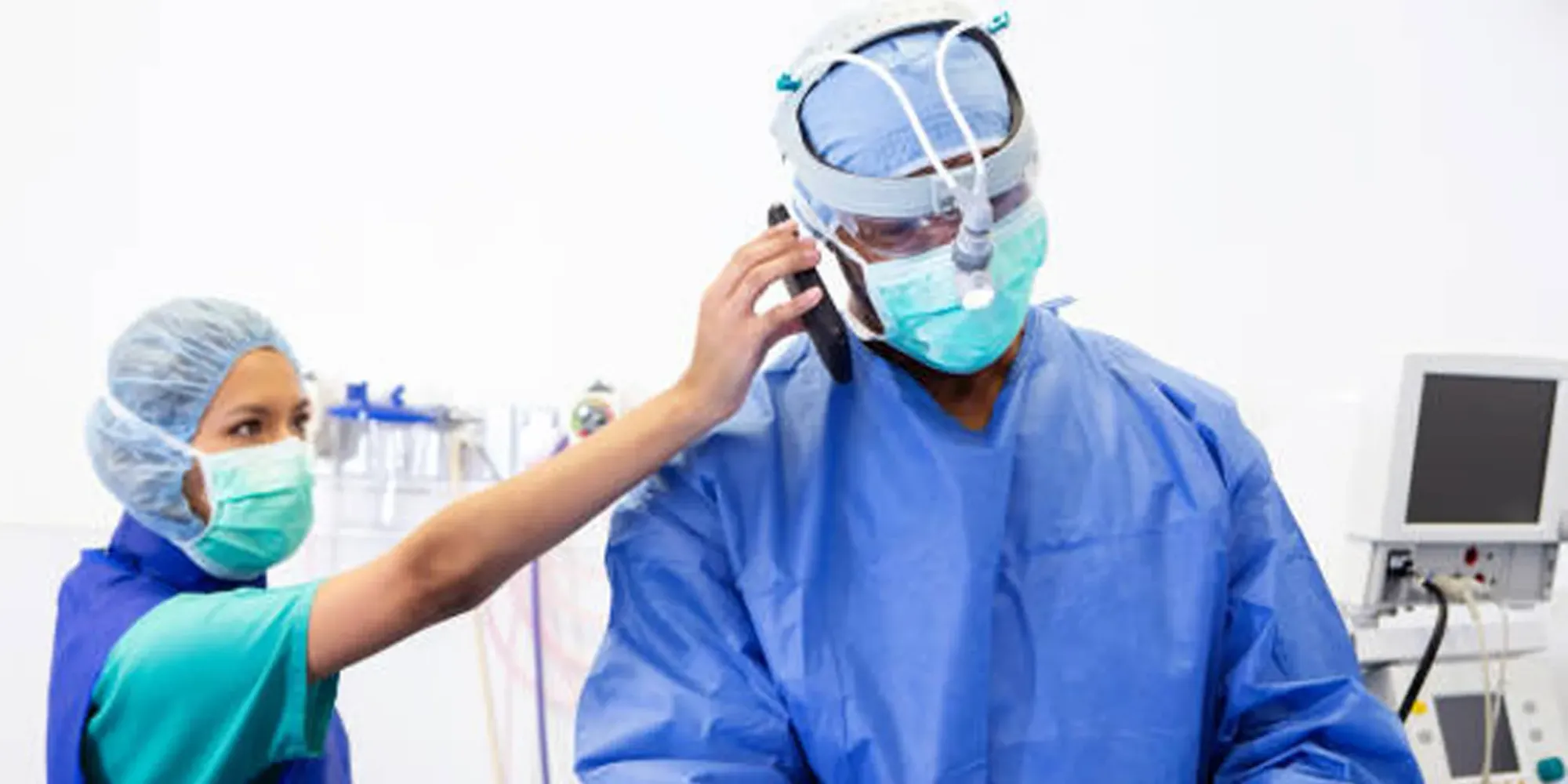 A surgeon taking a phone call in the operating room